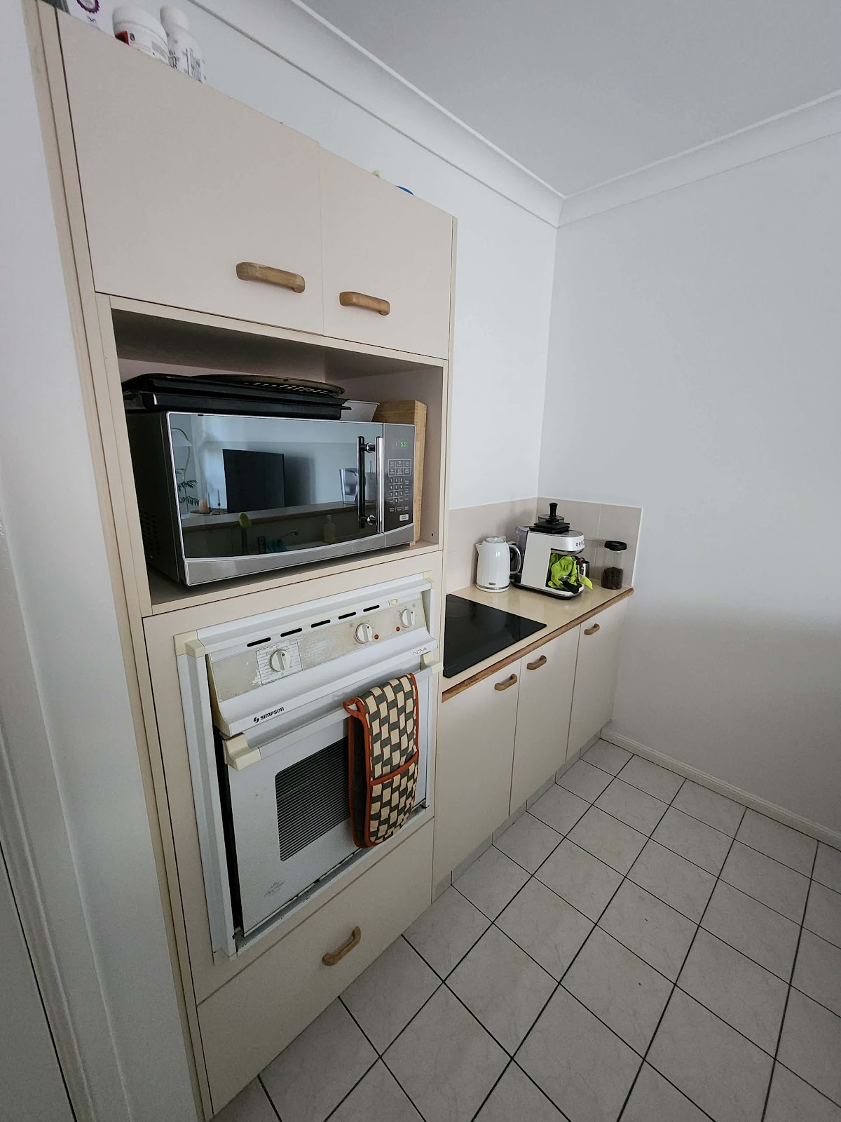 Before: old wall oven tower beside a short bench